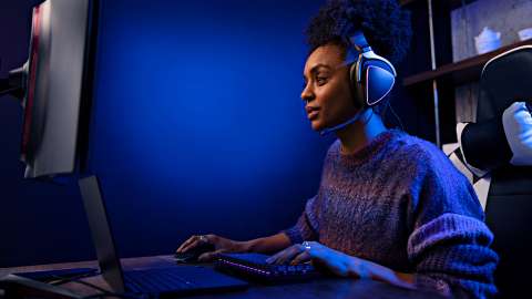 Female gamer at home wearing headset